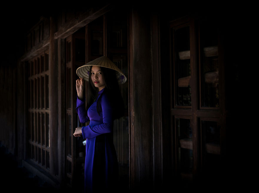 The young, graceful girls in traditional custom (ao dai),walking in the Temple ( Photo by Metin Diken)